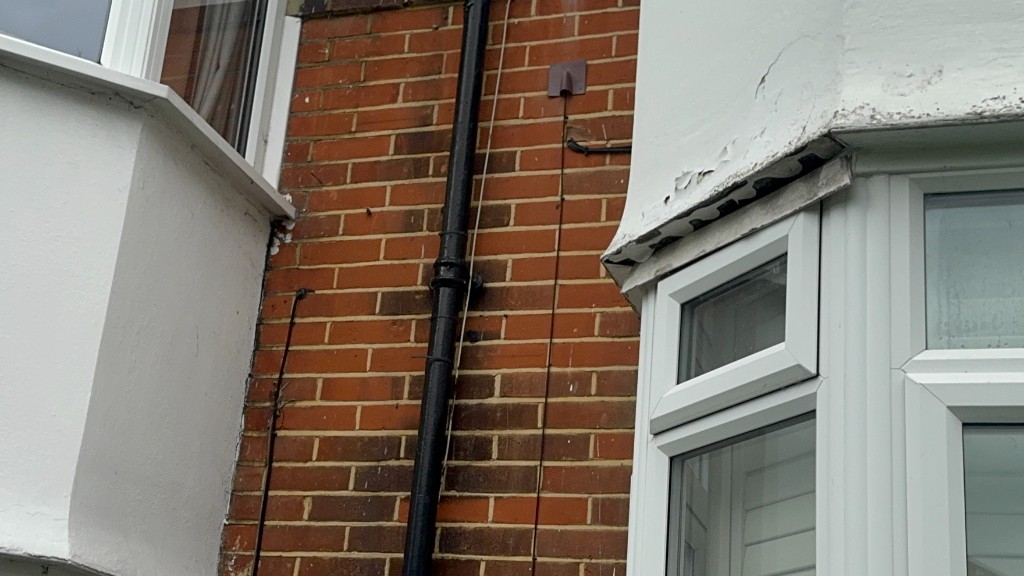 Red brickwork and a bay window on a surveyed property